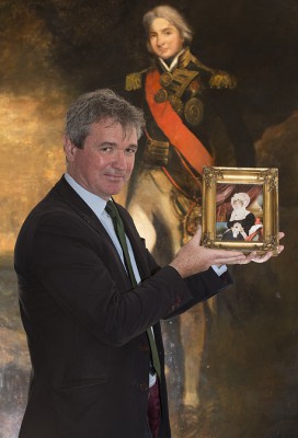 Martyn holding a newly-discovered portrait of Lady Nelson